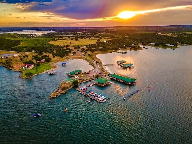 PRIME RESIDENTIAL & COMMERCIAL DEVELOPMENT OPPORTUNITY at Possum Kingdom Lake! The Sale includes The BREAKERS MARINA with Two Story Residence or Restaurant with ADDITIONAL 11.7 ACRES of Spectacular Waterfront & Interior Land perfect for FUTURE RV PARK, LAKE HOMES, CONDOS & or STORAGE. The Marina has 6 Docks with 56 Rental Slips, Retail Ship Store, Gas Dock, Jet Ski lifts, Public Restrooms, Boat Ramp with Ample Trailer Parking, PLUS the 2 story 2453 SqFt Restaurant and Bar have breathtaking Waterfront Views of PK, on an amazing Panoramic Point with ample room perfect for Private Parties, Concerts, and Events. All this is located off FM 1148. By land, on the Beautiful Westside of PK Lake, only 20 mins from Super Walmart, Shopping, Dining and Amenities in the small charming town of Graham TX. The location via lake is also centrally located just across from the Peninsula,& Eastside of PK & a short boat ride to the Famous Landmark Hell's Gate.  This is a Rare Development Opportunity on PK!