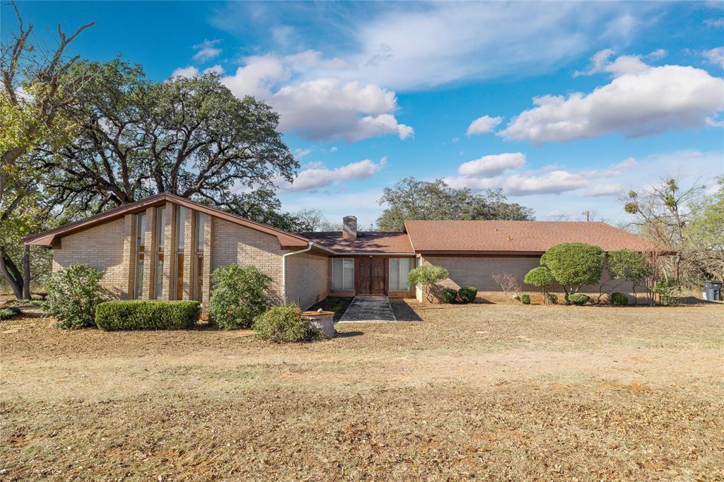 Discover the space, setting, and potential you’ve been searching for with this 2,489 sq. ft. home situated on approximately 1.75 acres in a desirable rural location just minutes from town. This property offers the best of both worlds, peaceful country living with quick, convenient access to local amenities. Inside, the home features 3 spacious bedrooms and 2.5 bathrooms, along with an abundance of living space that’s perfect for gathering, entertaining, or relaxing at home. The primary bedroom is coupled with a functional split design bathroom that is perfect for a shared space. You’ll find two dining areas, a large living room, and an oversized den centered around a cozy wood-burning fireplace. A standout feature of the home is the large windows that line the rear of the home in the den, living, and primary bedroom, offering an abundance of natural lighting. Enjoy the convenience of the attached, unique, and oversized garage with glass doors. With excellent potential, generous square footage, and a beautiful rural setting on manageable acreage, this property is ready for its next chapter. Bring your vision and make this remarkable home your own.