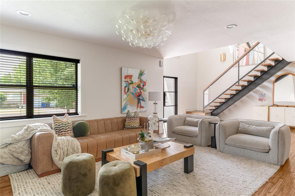 Located in the heart of Midway Hollow, this extensively renovated and thoughtfully expanded modern transitional home offers a seamless blend of elevated design, functional living, and meaningful upgrades. With over $500,000 invested, every detail has been intentionally curated to deliver both refined style and long-term livability. Natural light fills the open-concept floor plan, where rich hardwood floors and expansive living spaces create a warm and inviting setting. The chef’s kitchen serves as the heart of the home, featuring high-end appliances, a commercial-style range with statement vent hood, designer backsplash, updated hardware, and a custom bar area with bold wallpaper, perfect for gathering.
The main living area is anchored by a built-in media wall and sleek electric fireplace, complemented by visual comfort light fixtures, sconces and designer finishes throughout. First floor offers exceptional flexibility with two guest bedrooms, each with a full bath, one currently styled as a dedicated office with custom built-ins and tailored window treatments.

Upstairs, the oversized primary suite offers a private retreat with a sitting area and a fully renovated spa-inspired bath featuring marble tile, designer finishes, elevated fixtures, and a generous walk-in closet. A substantial expansion adds two additional bedrooms, two bathrooms, walk-in closets, a secondary utility space, and multiple living areas.

Recent improvements include a new roof, additional HVAC system, and tankless water heater all completed in 2025, along with extensive cosmetic updates throughout.

The outdoor space features a heated pool, retractable awning with integrated heaters, refreshed landscaping, and custom wood planters, creating a private setting for year-round enjoyment.

Ideally located near the Dallas North Tollway and premier private schools, this home offers turnkey living in one of Dallas’ most desirable neighborhoods.