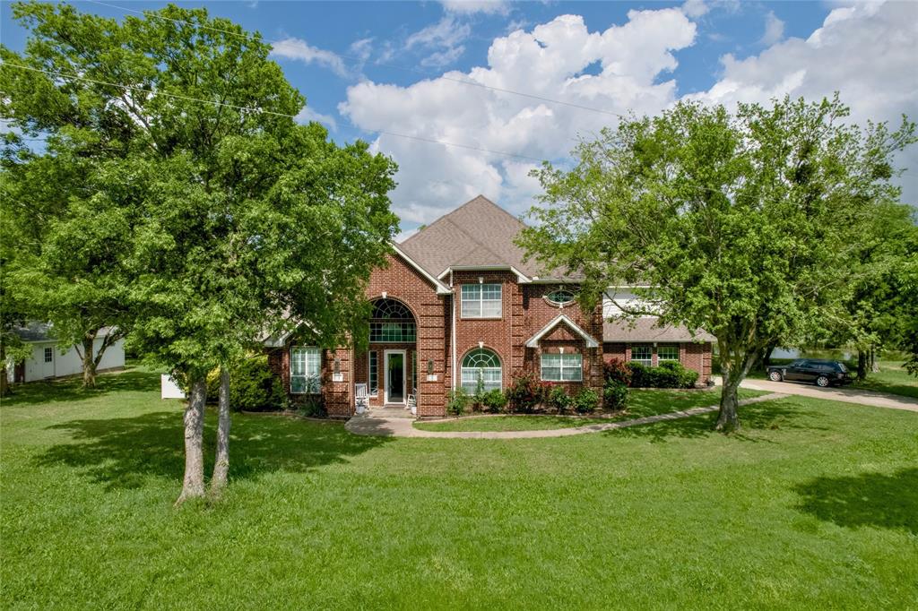 Experience the pinnacle of luxury and privacy in this breathtaking executive-style home, set on 5.015 acres with mature trees and a serene private pond. Offering 3,482 square feet of refined living space, this exceptional residence features three spacious bedrooms, two full baths, and two half baths, all designed with comfort and sophistication in mind. A dedicated home office showcases custom-built-ins, extensive shelving, and elegant raised-panel walls with beveled molding accents.

Natural light pours through oversized windows, creating a bright, airy atmosphere throughout. The formal dining room—currently used as a sitting area—features plantation shutters and flows seamlessly into the expansive family room, anchored by a gas-log fireplace and flanked by custom built-in storage.

The gourmet kitchen is designed for both function and style, featuring an extended island with prep sink, electric cooktop, and built-in double ovens. A charming breakfast area opens directly to the back patio, blending indoor and outdoor living. The main-level primary suite offers a private retreat with its own gas-log fireplace, patio access, spa-like bath with dual vanities, jetted tub, separate shower, and a large walk-in closet.

Upstairs is dedicated to entertainment, with a spacious bonus room, wet bar, media room, and game room with access to a private balcony overlooking the pond and scenic landscape. Exterior features include attached and detached garages, a powered storage building, and covered RV parking with hookups.

The property’s natural beauty provides privacy and tranquility, with a perfect balance of open space and mature trees. Whether entertaining or enjoying quiet mornings by the water, this estate offers a rare blend of luxury and peaceful country living.