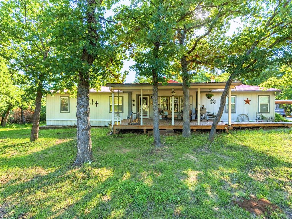 Tucked away on 4.66 peaceful acres just minutes from town, this well-maintained 4 bedroom, 2.5 bath mobile home offers the perfect blend of quiet country living and everyday convenience. Inside, you’ll find a spacious kitchen with a cozy breakfast nook, plus a separate dining room just off the kitchen, ideal for gatherings and entertaining. A convenient half bath is located next to the laundry room for added functionality. Step outside onto the beautiful decks located at each entrance and enjoy morning coffee or breathtaking sunsets. The property also features a large 4-car carport, two storage buildings, and a charming bunk house just a short walk from the main home. Complete with a porch, kitchenette, full bathroom, and small loft, the bunk house is perfect for guests, extended family, or a private getaway space. Explore the walking trails throughout the property and pathways guiding you through the landscape and over to the impressive 30x40 metal shop featuring a concrete floor, bay door, and windows, ideal for hobbies, storage, or workspace needs. Secluded, peaceful, and full of charm, this property offers room for animals, space to roam, and the feeling of being on vacation every day.
