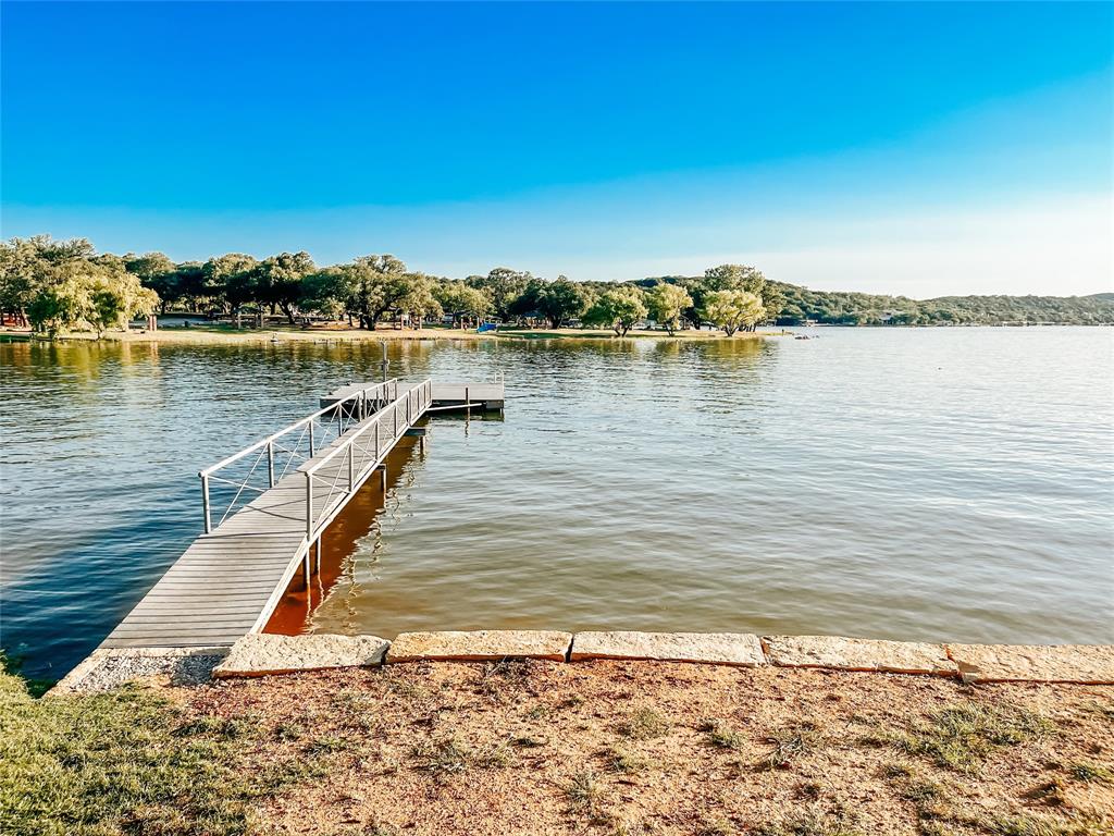 Sandy Beaches, gorgeous views, This lakefront property is one of the best locations on the lake. Friendly access to over 100' shoreline of sandy beach make it a great place for swing or water games. The covered deck is perfect for watching the kids play or the gorgeous views while enjoying a cold drink. The cabin is spacious with the kitchen and living room having an open concept, only one bedroom but there is room for another bedroom or two. Boat-Fishing dock plus a boat ram.