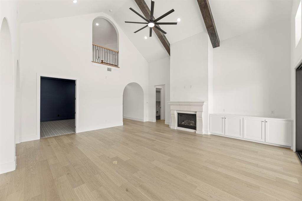 MLS# 21199776 - Built by Tradition Homes - Ready Now! ~ This expansive two-story home offers six bedrooms and six-and-a-half baths, introduced by a double door entry and an elegant curved staircase. At the heart of the layout, the great room flows seamlessly into the kitchen and hearth room, complemented by a functional prep kitchen. Sliding glass doors open to the extended covered outdoor living, establishing a refined indoor-outdoor connection ideal for entertaining. The private owner’s suite features a bay window and spa-inspired bath, while a dedicated study and versatile flex room enhance the main level. Upstairs, a spacious gameroom and secondary bedrooms provide comfortable separation and flexibility throughout. A four-car garage completes this thoughtfully designed home on one of the largest lots in this section of Mustang Lakes.  HIGHLY ACCLAIMED Prosper ISD