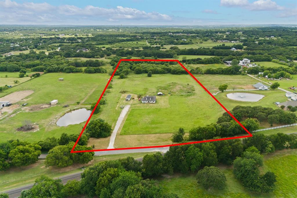 RARE opportunity to own 14 acres with a home in this area under $1M—perfect for those dreaming of space, privacy, or a future family compound. Located outside city limits yet within Mansfield ISD, this property offers the freedom and flexibility buyers are searching for.
The home sits thoughtfully within the front 4 acres, allowing the remaining acreage to be used however you envision—additional homes, a workshop, livestock, recreation, or long-term investment. The land is mostly flat with endless potential.

Inside, enjoy an open-concept layout connecting the living, dining, and kitchen areas, complete with two separate sitting spaces in the living room. The home features wood-look ceramic tile throughout the main living areas, granite countertops in the kitchen and baths, and fresh interior paint. Carpet is limited to the primary bedroom and 4th bonus room.
The primary suite includes an adjoining flex room—ideal for a 4th bedroom, home office, nursery, or craft room, offering flexibility for changing needs.
A NEW ROOF will be installed prior to closing for added peace of mind.
An added bonus: 13 acres are Ag Exempt for hay, creating an excellent opportunity for income production—either by selling hay or leasing the land.
Whether you’re looking to build a multi-generational family compound, create income-producing land, or simply enjoy wide-open space with NO CITY Restrictions, this property delivers rare versatility and long-term value.
**Tiny House will be removed!**