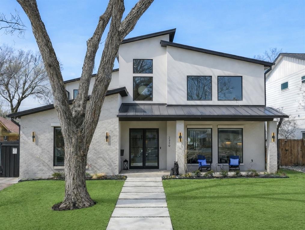 Zoned to Lakewood Elementary and completely rebuilt in 2023, this architecturally striking residence sits on an oversized lot and showcases a thoughtful, well-designed layout ideal for both everyday living and effortless entertaining. Large windows fill the home with natural light, highlighting the stunning designer tile selections, elevated lighting, and clean architectural lines throughout. The main level offers incredible entertaining spaces with soaring 20’ ceilings in the living and dining areas, a private office with custom built-ins, and a luxurious primary suite. An additional downstairs bedroom provides flexibility as a secondary living space, guest suite, or second office. The kitchen is a true centerpiece, featuring designer finishes, stainless steel appliances, a built-in refrigerator, wine fridge, refrigerated drawers, and an oversized island that anchors the open-concept living space. Upstairs, three generously sized bedrooms each feature ensuite baths, along with an additional office or homework area perfectly suited for today’s lifestyle needs. Outdoor living is equally impressive with a covered patio with automatic screens overlooking the sparkling pool and spa, custom finished pool decking, and a low-maintenance turfed yard designed for year-round enjoyment. The home is fully smart-home enabled and prewired with whole-house Ethernet, offering seamless connectivity for networking, audio, and streaming. Additional highlights include wood floors throughout, smooth finish walls, a whole-home generator and a pool cooler for warm Texas summers. An attached oversized two-car garage includes two EV charging ports and provides ample room for storage and functionality. This exceptional Lakewood Elementary home blends sophisticated design with comfortable, livable spaces — a rare opportunity not to be missed.