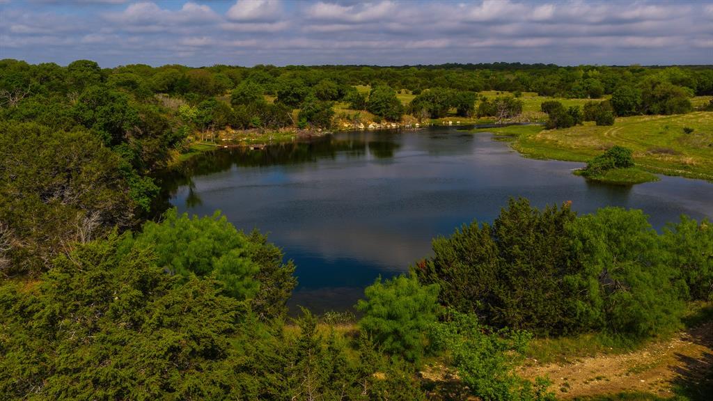 This exceptional 167-acre ranch in Hamilton County, Texas offers a rare blend of natural beauty, functionality, and investment potential. Fully fenced and thoughtfully maintained, the property features a picturesque 3-acre lake fed by a reliable solar-powered well, providing a sustainable water source year-round. Lake is perfect for kayaking and fly fishing. It is stocked with Copper Nose Bluegill, Largemouth Bass, Spotted Bass and Channel Catfish. Scattered throughout the landscape are impressive clusters of mature oak trees, creating a serene setting with plenty of shade and character.

The land is currently under a wildlife exemption, offering significant tax advantages while supporting native habitat and recreational opportunities. Whether you're looking for a private retreat, a hunting property, or a working ranch, this versatile acreage delivers. Wide-open spaces, gently rolling terrain, and abundant wildlife make this property a true slice of Texas countryside at its finest.

POF or Prequalification is required before showing appointment will be approved. SOP. House, barndo and all improvements plus 24 acres will also be for sale soon. See Transaction desk for helpful info on the property. The owner spared no expense on this property, Its truly one of a kind. Blinds and Feeders will convey with the sale.