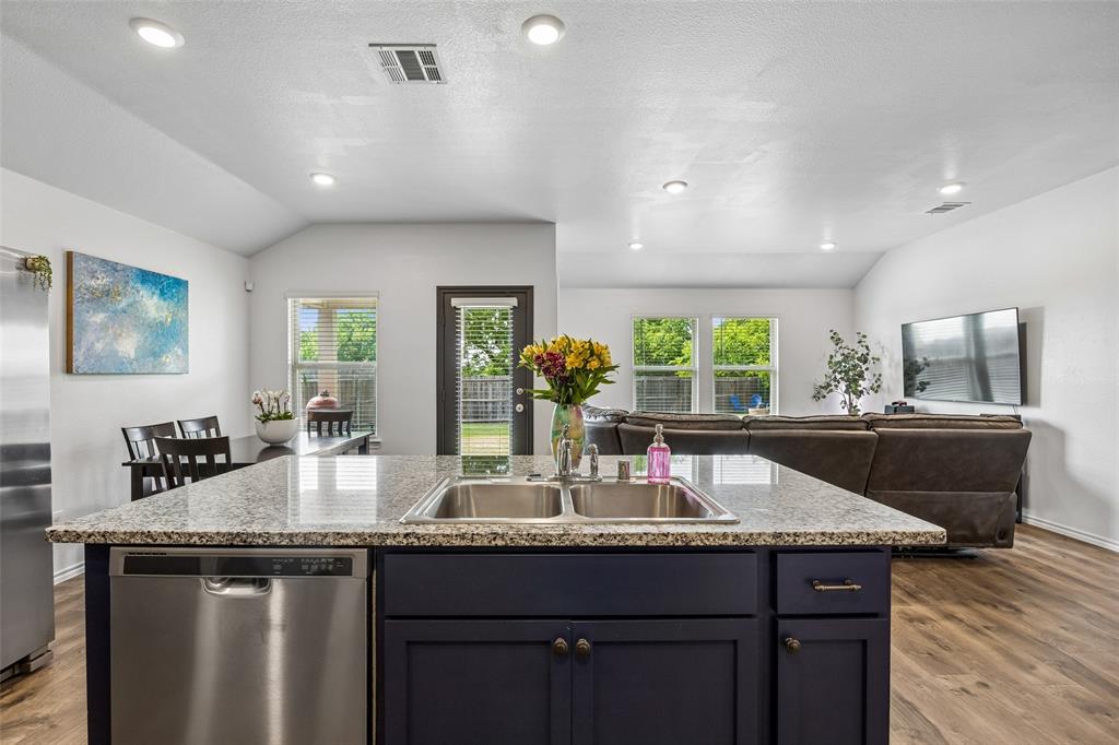 Now offered at an even sweeter value, 802 Rustic Way brings together big backyard living, smart design, and Magnolia community charm in the growing Josephine-Royse City area. This 4-bedroom, 2-bath home sits on an oversized lot with a wood-fenced backyard that backs to municipal property, giving you a peaceful tree-lined view instead of rear residential neighbors. Inside, arched details, high ceilings, fresh paint, and an open living, dining, and kitchen layout create an easy, welcoming flow for everyday life. The kitchen features designer navy cabinetry, granite countertops, electric cooktop and oven, refrigerator that conveys, designer hardware, over-cabinet lighting, and a motion-activated pantry light. Thoughtful upgrades include Lutron lighting, LED lighting, wall shelving, landscape lighting, and an epoxy-finished garage floor. The split-bedroom floor plan gives buyers flexibility for guests, work from home, hobbies, fitness, little ones, or visiting grandkids. Two secondary bedrooms share a full bath at the front of the home, while a third bedroom offers ideal flex space as an office, nursery, guest room, or workout room. The private primary suite overlooks the backyard and includes abundant natural light, double sinks, oversized shower, generous linen storage, and a large walk-in closet. Outside, the oversized yard offers room to relax, garden, play, entertain, or dream bigger. Fire pit and play set may convey. Just a few feet away, Magnolia’s trail system connects to the elementary school, parks, playgrounds, sports fields, and green space. Magnolia residents enjoy resort-style pools with water park features, food truck rallies, Magnolia Market pop-ups, and a connected neighborhood feel. If you need peace, certainty and a great deal on a well maintained home, Rustic house is the place!