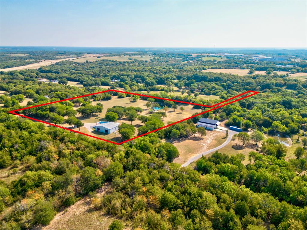 Enjoy no HOA and a full AG Exemption (January 2024)!  Just under 10 acres with a huge 2400 square foot shop and 2 BR, 1.5 BA barndominium, close to Hwy 75.  Perfect for a small business needing room for their equipment or for someone with a lot of toys to store – ATV’s, boats, or RV’s.  Property features multiple upgrades including new HVAC, new appliances, new hot water heater and new flooring.  Tons of possibilities - Keep the home as is, live in it while building your dream home, or subdivide.  Close to Lake Texoma, the property is a great investment opportunity.  The ongoing $30 billion expansion of the renowned Texas Instruments plant in Sherman and GlobeTech expansion enhances the area's economic growth and potential. This property is also located across Hwy 75 from the newly planned Texoma Technology Park and just south of the upcoming Preston Harbor development on the shores of Lake Texoma.