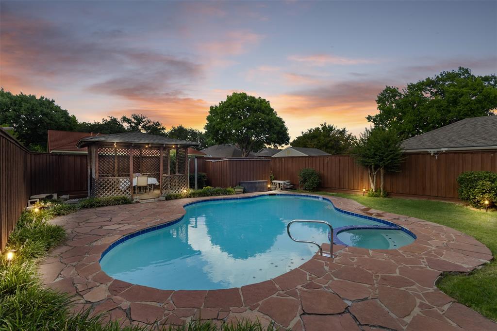 Welcome to this beautifully updated North Dallas home in a highly desirable Country Brook neighborhood zoned to acclaimed Plano ISD. Designed for comfortable everyday living and easy entertaining, the home offers abundant natural light, spacious living areas, flexible spaces, and updated finishes throughout. The private backyard is a true retreat, perfect for entertaining those summer nights or enjoying your morning coffee. Featuring a sparkling pool, relaxing hot tub, covered gazebo, natural gas outlet, grassy yard, and board on board privacy fence. Whether hosting summer pool days or unwinding at the end of the day, this outdoor space is ready to enjoy year-round. Inside, the living room with built-ins overlooks the backyard, while the sunroom-flex space offers pool views and is ideal for a home office, playroom, exercise room, or creative studio. Renovated bathrooms include quartzite countertops, updated fixtures, and spacious walk in showers. The kitchen features a built-in pantry with ample shelving and drawers and is conveniently located near the dining, living, and laundry areas, with a bathroom nearby for easy backyard access. Recent updates provide valuable peace of mind, including energy-efficient windows, updated HVAC systems, new pool equipment, interior and exterior paint, new carpet, manufactured wood floors, updated electrical outlets, replaced circuit breaker panel, and a new water heater with automatic cutoff valve. Additional highlights include an oversized garage with room for a truck, a 50- amp generator hookup, storage shed for gardening tools, a very long flat driveway and a finished walk-up attic offering generous storage. Located near a pond for walking or fishing, shopping, dining, and major routes including the Dallas North Tollway, George Bush Turnpike, and I-35, this home offers convenience, flexibility, meaningful updates, and an exceptional backyard in one of North Dallas’ most desirable areas. Country Brook is a great community.