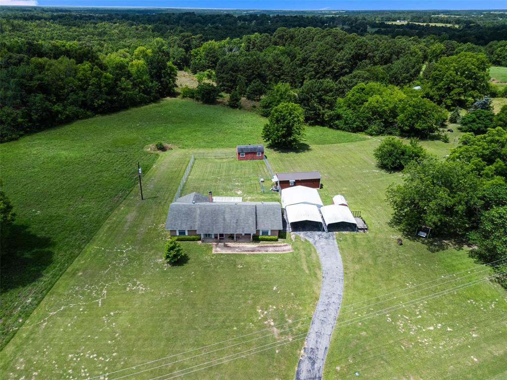 Discover the perfect blend of space, versatility, and East Texas charm at this exceptional property situated on 3.918 beautiful acres in the desirable Union Grove ISD. This well-maintained 2000+ sq ft home offers plenty of room for family and entertaining with two spacious living areas, providing flexible spaces for gathering, relaxing, working from home, or creating a game room. Summer of 2025 welcomed the complete HVAC replacement inside and out, water heater replaced and exterior paint.

Outside, the possibilities continue with an additional 384 sq ft 1 bedroom 1 bath tiny house ideal for guests, multigenerational living, a home office, rental income opportunity, or hobby space with a fenced in yard fitting its tiny space. A large storage building provides ample room for tools, equipment, and seasonal items, helping keep everything organized. 

Car enthusiasts, hobbyists, and those needing extra covered parking will appreciate the impressive combination of a detached two-car garage and two two-car carports with an additional smaller storage building, offering abundant space for vehicles, boats, RVs, or recreational equipment.

Enjoy the privacy and freedom of nearly four acres while still benefiting from the highly regarded Union Grove school district. Whether you're looking for room to grow, space for hobbies, or a property with endless possibilities, this unique Gilmer-area retreat is ready to welcome you and your family home.

This gem offers the rare combination of acreage, versatility, and sought-after school district living—don't miss your opportunity to make it yours!