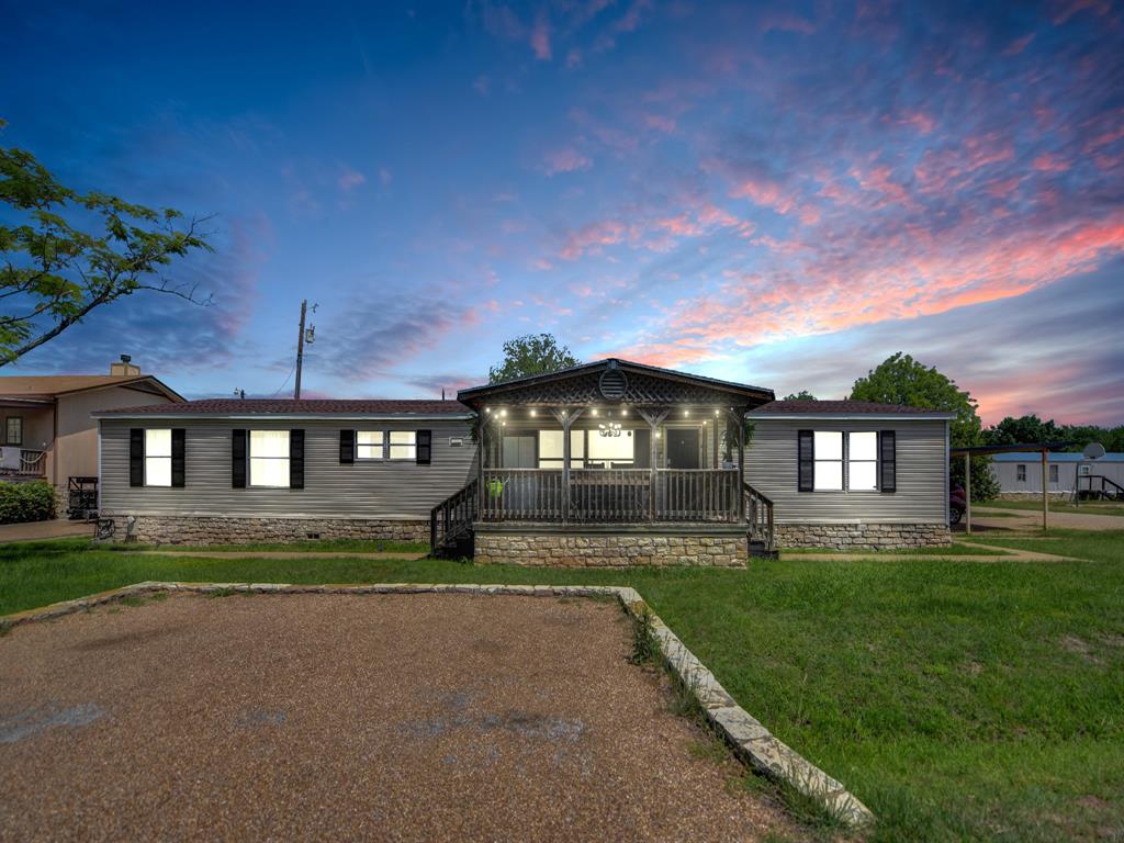 Welcome to 5402 Clear View Drive, a spacious retreat nestled in the peaceful Arrowhead Shores community of Granbury. This 4-bedroom, 2-bath home offers over 2,000 square feet of comfortable living space on a generous lot, blending functionality with relaxed Texas charm. Featuring an open-concept layout, the home includes multiple living and dining areas ideal for entertaining or everyday living. The kitchen offers abundant counter space, granite surfaces, and a large island that flows seamlessly into the main living area, creating a warm and inviting atmosphere. The split-bedroom design provides privacy for the primary suite, while additional bedrooms offer flexibility for guests, a home office, or growing families. Enjoy outdoor living with a spacious backyard featuring deck and patio space perfect for gatherings, relaxing evenings, or weekend barbecues. Located near parks, lake access, and neighborhood amenities, this property offers the perfect balance of small-town charm and convenience. Just minutes from historic downtown Granbury, shopping, dining, and the scenic shores of Lake Granbury, this home is a fantastic opportunity to enjoy peaceful living with easy access to everything Granbury has to offer.