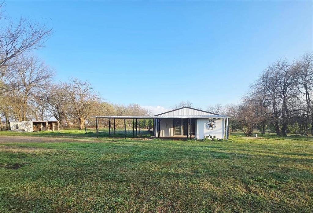 Unique 3-bedroom, 2-bath metal shop house situated on almost 1 acre, outside city limits.  The property features laminate flooring throughout, tons of natural lighting, a fully fenced yard, and no restrictions, offering endless possibilities for residential use, rental potential, or small business flexibility.  Located in Bland ISD, this rare setup provides both space and versatility.  Plenty of room for animals & entertaining guests.