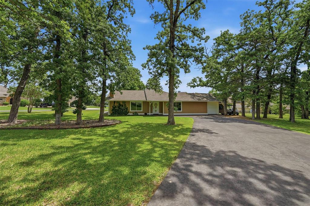 This charming 2 bedroom, 2 bathroom home is filled with character, comfort, and spaces designed for making memories. Tucked beneath mature trees on a spacious corner lot, the home’s elevated main living area is open, airy, and drenched in natural light, creating a warm and inviting atmosphere from the moment you walk in. Wood vaulted ceilings soar above the living room, while a stunning statement fireplace with beautiful custom detailing creates the perfect focal point for the space. Modern concrete floors add a stylish and contemporary touch throughout the home, blending warmth and durability with effortless design.

The kitchen is ready for cooking and entertaining with granite countertops, stainless steel appliances, and a functional layout that flows seamlessly into the main living spaces. A sliding glass door provides easy access to the patio, making grilling, outdoor dining, and evenings under the trees effortless and enjoyable.

A standout feature is the adorable bonus bunk room, thoughtfully designed with built-in beds, playful hideaways, and endless opportunities for sleepovers, imagination, and adventure. Whether it’s a cozy reading nook, game space, or the ultimate kids’ retreat, this room is sure to steal the show.

Outside, the fun continues with a front driveway perfect for basketball games and evenings spent gathering and relaxing on the patio surrounded by mature trees and landscaping. With its unique character, inviting spaces, and thoughtful details throughout, this home offers the perfect blend of charm, style, and functionality for everyday living and unforgettable moments.