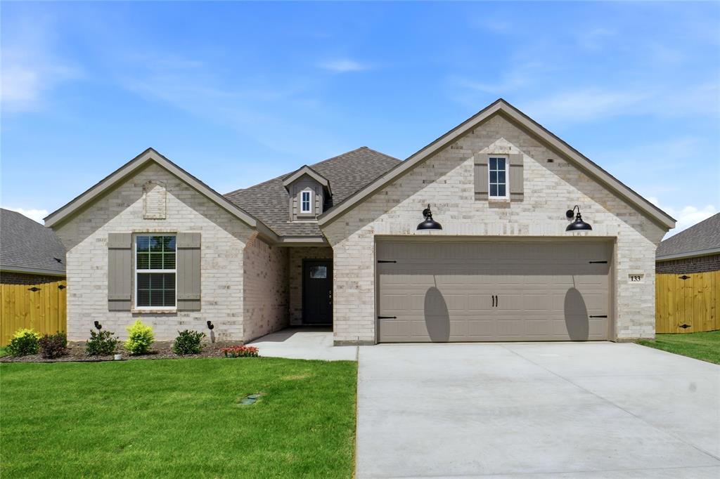This stunning new custom-built home 4 bedroom home seamlessly blends modern luxury with everyday comfort, offering an open-concept layout perfect for entertaining and relaxed living. The heart of the home is a chef-inspired kitchen featuring a large central island with elegant quartz countertops, providing ample space for meal prep, casual dining, and gathering with family and friends. Vaulted ceiling and electric fireplace highlight the living area. High-end finishes and thoughtful design details elevate the space, while luxury vinyl plank flooring flows throughout the home, delivering durability, easy maintenance, and a warm, sophisticated look underfoot.
The primary bathroom is a true spa-like retreat, complete with dual vanities for convenience, a luxurious freestanding soaking tub, and a spacious walk-in shower adorned with beautiful waterfall tile that adds texture and a sense of serenity, not to mention the master closet loaded with shelving. Additional highlights include a pristine garage with a durable, glossy epoxy floor that is both functional and showroom-worthy. Step outside to enjoy the covered patio—an ideal extension of the indoor living space for al fresco dining, relaxing, or hosting guests. The beautifully landscaped yard, complete with a professionally installed sprinkler system, ensures year-round curb appeal. This custom home offers the perfect balance of high-end features, practical design, and modern amenities, making it an exceptional place to call home. Every detail has been thoughtfully selected to create a luxurious yet livable environment tailored to your lifestyle
