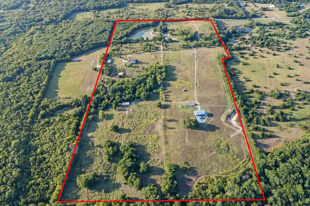 A 64.02-acre development assemblage in the direct path of Anna's growth — three contiguous parcels along County Road 581, positioned for a full master-planned single-family neighborhood in one of Collin County's fastest-expanding corridors. With roughly 1,164 continuous feet of frontage on CR 581, the tract offers generous, flexible primary access — room for a signature entry and multiple connection points to feed an internal street network.
This is a developer's canvas, not raw dirt. Electricity, water, and sewer already serve the property, with electric service, water (including an on-site well), and septic infrastructure already distributed across the acreage — a head start on horizontal cost and timeline. Topography is level to gently rolling. Held within the City of Anna's ETJ, the land can be divided at one acre per parcel under current septic guidance (pending review) as a conservative floor — but with sewer available to connect, the real upside is platting to municipal density and building out a full neighborhood, where every lot draws frontage from interior streets rather than the county road. Yield is governed by your lot program and net developable area, not by road frontage.
As rooftops push north out of McKinney and Melissa, contiguous acreage of this scale — with access, utilities, and a clear density path already in place — is increasingly scarce. Bring your engineer and your neighborhood plan. Survey, parcel detail, and supporting materials available to qualified parties.