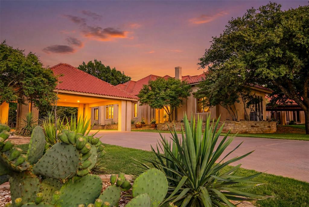 Perched atop rolling terrain with panoramic views of Lake Ray Roberts, this beautifully renovated Mediterranean-style estate spans 58± acres in one of North Texas’ most desirable locations. Combining luxury living, privacy, and versatility, the property is minutes from downtown Pilot Point, marinas, and boat docks less than two miles away.

Originally built in 1998 and renovated in 2025, the 5,760± square-foot residence showcases Mediterranean architecture with stucco exteriors, tile roofing, a porte cochère, private courtyard, four fireplaces, a balcony, and hilltop views. The home offers four bedrooms, three full bathrooms, one half bath, multiple living areas, flex spaces, a wet bar, quartzite countertops, a Sub-Zero refrigerator, and Viking gas range. An attached one-bedroom casita with authentic Saltillo tile provides additional guest accommodations.

Additional improvements include a 738± square-foot guest house, a 45' x 50' shop with half bath, dog kennels, pipe fencing, cross-fenced pastures, and two ponds, including a stocked fishing pond with its own private island.

Highlights include a private deep well with an 18,000-gallon holding tank, underground utilities, access to public water and sewer along Walcott Street, a FEMA-certified safe room, automatic gated entrance, and agricultural tax exemption. Walcott Street is a quiet dead-end road offering exceptional privacy and minimal traffic.

Approximately 50 feet of elevation change provides long-range views, while mature trees, water features, and rolling pastures enhance the property's beauty and functionality. Currently utilized for longhorn cattle, the ranch is equally suited for livestock, recreation, equestrian use, or simply enjoying the North Texas countryside.

Located outside city limits with no restrictions, this exceptional property offers endless possibilities as a private family compound, luxury retreat, event venue, bed and breakfast, or working ranch.