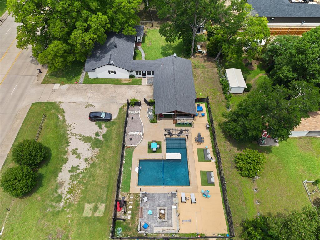 Discover a truly one-of-a-kind property offering endless possibilities on nearly 0.75 acres with NO HOA, incredible privacy, and a backyard designed to impress! Whether you're searching for a personal retreat, multigenerational living setup, or income-producing property, this rare gem delivers. The unique floorplan features a 1,857 sf main home with 3 Bedrooms and 2 Bathrooms, connected by an interior breezeway to a fully equipped guest house, studio, or pool house complete with its own Great Room, Kitchen, and Full Bathroom—perfect for guests, long-term stays, private office space, or rental income. Inside, the beautifully updated interior showcases new Luxury Vinyl Plank flooring throughout, new windows, plantation shutters, granite countertops, stainless steel appliances, and flexible living spaces designed for modern lifestyles. The spacious Living Room opens to an additional Flex Room ideal for a home office, reading nook, playroom, or secondary living space. Step outside and experience the backyard paradise the sellers thoughtfully created with over $200K invested into outdoor living and entertaining! The resort-style setting includes a sparkling pool, expansive stamped concrete, built-in seating areas, fire pit, pergola, multiple patio spaces, and wood fencing. The covered outdoor living and grilling area is fully equipped with grill space, prep area, and room to relax—creating the ultimate space for entertaining, celebrations, or simply undwinding in complete privacy. Adding even more value, this oversized backyard and impressive amenities create unique income-producing opportunities through platforms like Airbnb or Swimply. Conveniently located near Lavon Lake and Firewheel Town Center for dining and entertainment, this exceptional property combines privacy, flexibility, recreation, and investment potential into one unforgettable package.
