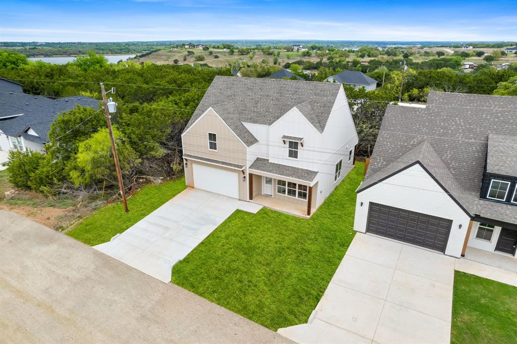 New construction, light-filled, and move-in ready in a gated neighborhood, near Lake Granbury! This stylish home offers 3 bedrooms, 2 full baths, 1 half bath, and 1,476 square feet of thoughtfully designed living space in the gated Canyon Creek community. The open-concept floor plan features abundant natural light, a neutral color palette, and fresh, modern finishes throughout. The kitchen flows seamlessly into the living and dining areas, creating a comfortable layout for everyday living and entertaining.
The primary suite on the main floor includes a private bath and walk-in closet, while two additional bedrooms and a full bath upstairs offer flexibility for guests, a home office, or additional living space. Enjoy the convenience of a 2-car garage, covered patio, privacy fence, and mature trees in the backyard.
Residents of Canyon Creek enjoy 24-hour manned gated security, two swimming pools, a clubhouse, tennis and basketball courts, playgrounds, a boat ramp, and a fishing dock. Whether you’re looking for a primary residence, low-maintenance retreat, or weekend getaway, this home offers comfort, quality, and value in a beautiful Lake Granbury-area setting.