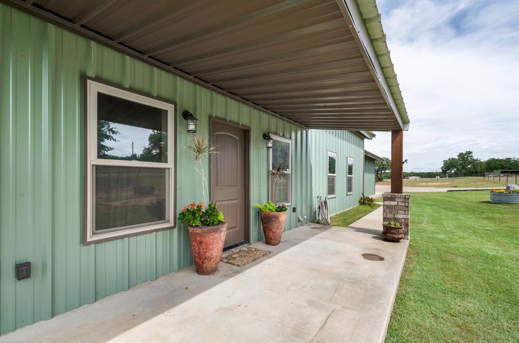 Country living at its finest! NO HOA and NO city taxes! Situated on 10 acres of sandy soil with pipe fencing and freshly dug tank adding beauty and practicality to the acreage. From the moment you step inside, you will appreciate one of the best home layouts you will find! Immaculately kept home that looks brand new. Floors are luxury vinyl plank that make cleaning a breeze! Open concept plan with tons of storage in the kitchen, extra large walk-in pantry, refrigerator, farmhouse sink and huge island with granite countertops and tucked-under bar stool seating for four. The kitchen flows seamlessly into the living area, where a cozy wood-burning fireplace serves as the focal point for gatherings with family and friends.  3 large bedrooms all with walk-in closets and a large bonus room that can easily be used as a game room, media room, office, hobby space or 4th bedroom. 2 full baths. Split bedroom arrangement for added privacy. A dedicated laundry room with a folding table adds extra functionality to daily living. Step outside and enjoy the covered back patio with a mounted outdoor television for game nights or relaxing in your favorite chair. Built with energy efficiency in mind, this home includes 1-inch closed-cell spray foam insulation PLUS batt insulation. Property includes private well (no water bills) and an aerobic septic system. Newly installed above the ground pool with waterfall is a beautiful way to cool off during warm Texas summers. 40x40 shop with electrical and plumbing and two large roll-up doors that will accommodate your motorhome or horse trailer including 30 amp outlet.  The flat, usable acreage offers endless possibilities, whether you’re looking to establish a horse property, raise livestock, build addition improvements, or simply enjoy freedom that comes with owning your own slice of Texas countryside.  This home is truly MOVE-IN READY!!  Located in the desirable Millsap school district. You will definitely want to see this one!!