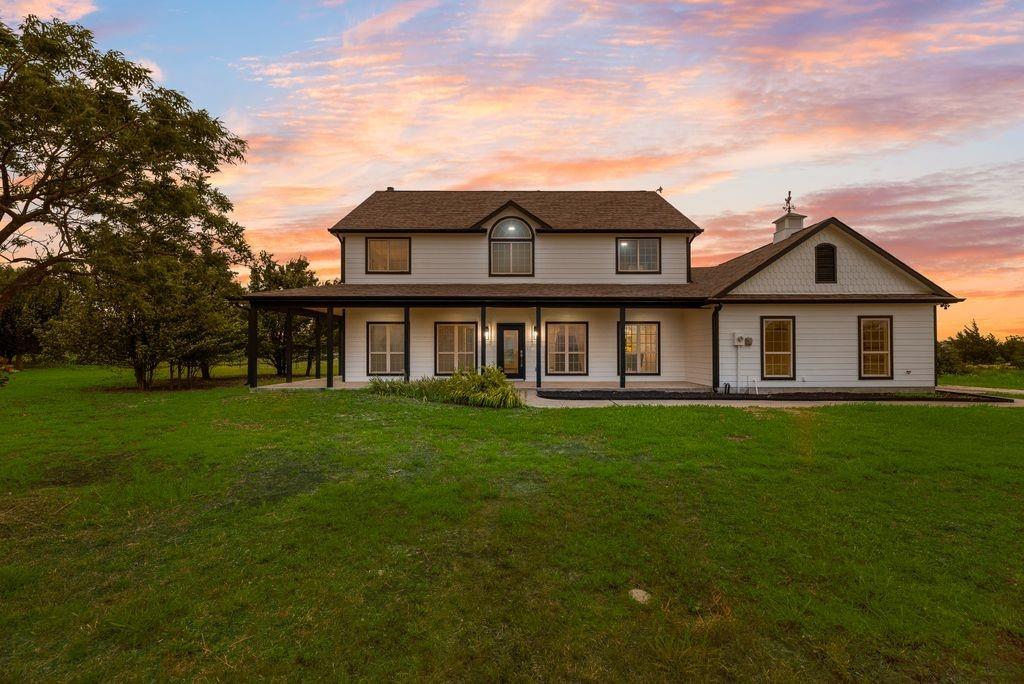 Five bedroom country retreat on 3.8 acres in McKinney ISD! This nearly 3,000 sq ft home features hardwood floors, a renovated kitchen with granite countertops and gas range, fresh interior and exterior paint, updated lighting, hardwood floors, and an expansive wrap-around porch. Flexible living spaces offer room for a home office, game room, or guest suite. Enjoy peaceful country living with room for horses, a pool, workshop, or garden — all just minutes from shopping, dining, and city conveniences. Additional features include a built-in storm shelter, 2-car garage, central vacuum system, fenced backyard, and mature trees for added privacy. Book a showing today!