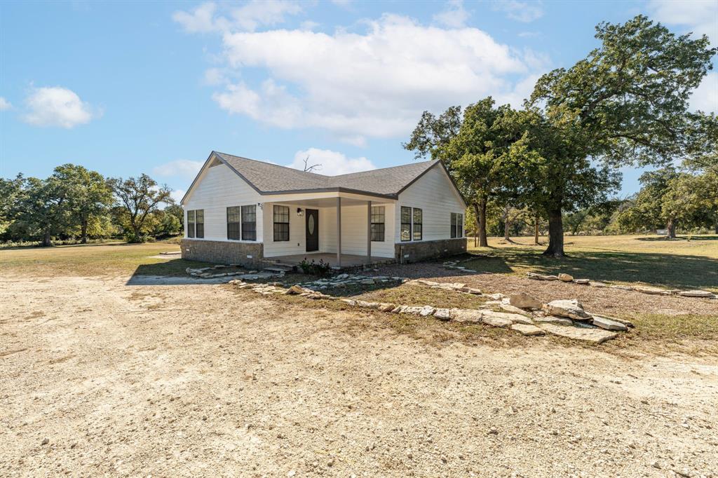 IMPROVED & UPDATED! Escape to the peace and quiet of the country with this beautifully updated 3-bedroom, 2-bath farmhouse nestled on 3.6 private, tree-covered acres just outside Stephenville. Mostly remodeled, the home features an open-concept layout with spacious living and dining areas, stylish finishes throughout, and a standout kitchen equipped with a premium THOR gas range—perfect for serious home chefs. Outside, the property offers a peaceful setting with mature oaks, a picturesque pond, and a large backyard ideal for relaxing or entertaining. You'll also find a water well, garden areas, fruit trees, and a versatile well house that can serve as a workshop or additional storage. With nature all around, this charming retreat offers the perfect blend of country living and modern comfort just minutes from town.