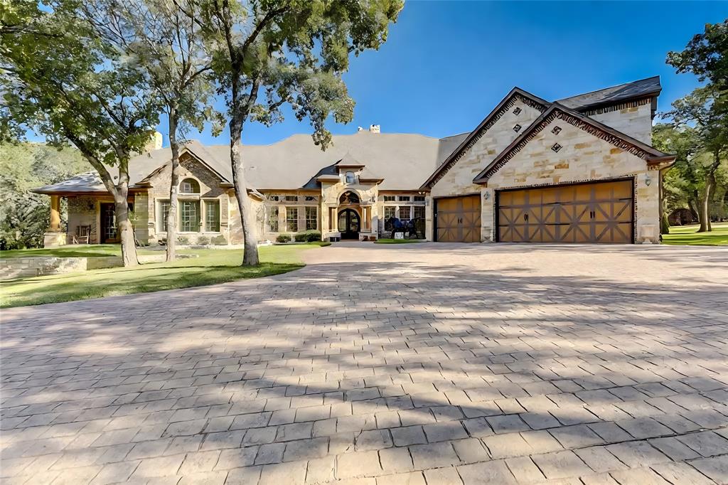 Luxury Living on roughly 5 Ag-Exempt Acres
This executive estate blends the best of land, luxury, and privacy—offering over 6,500 sq. ft. of living space, nearly all on one level. With an active agricultural exemption, this property provides the rare combination of wooded acreage, open pasture, a stocked pond, and a large barn.
The residence itself is designed for both comfort and grandeur. A dramatic foyer with soaring ceilings and tiered chandeliers sets the tone for open, elegant entertaining. The Primary Wing feels like its own retreat, featuring an expansive bedroom, private lounge, a secondary office with its own entrance, three oversized closets, and a spa-like bath. Throughout the home, hand-scraped hardwood floors and rich wood finishes create a warm, refined atmosphere.
The chef’s kitchen, anchored by Viking commercial-grade appliances, is built for gatherings and culinary creativity. Every bedroom offers its own ensuite bath and private patio, creating a blend of comfort and independence for all who stay.
Outdoors, enjoy sweeping views from multiple patios, including direct sightlines to the barn, pond, and much of the acreage. The land is fully fenced and cross-fenced with more than 2,200 feet of pipe rail, while an electric gate leads to the main drive. A massive barn provides space for equipment, hay, and even a workshop.
Located just 5 miles from Denton, 2.5 miles from dining and shopping in Cross Roads, and 11.5 miles from the PGA of America’s Frisco headquarters, the property is perfectly positioned for convenience while remaining secluded. With no city taxes, undeveloped Corp of Engineers land across the road, and neighboring properties that also feature multi-acre tracts, this estate promises lasting privacy.
Additional acreage, a second barn, and a ranch house can also be acquired creating the potential for a truly expansive retreat. See MLS # 21074228