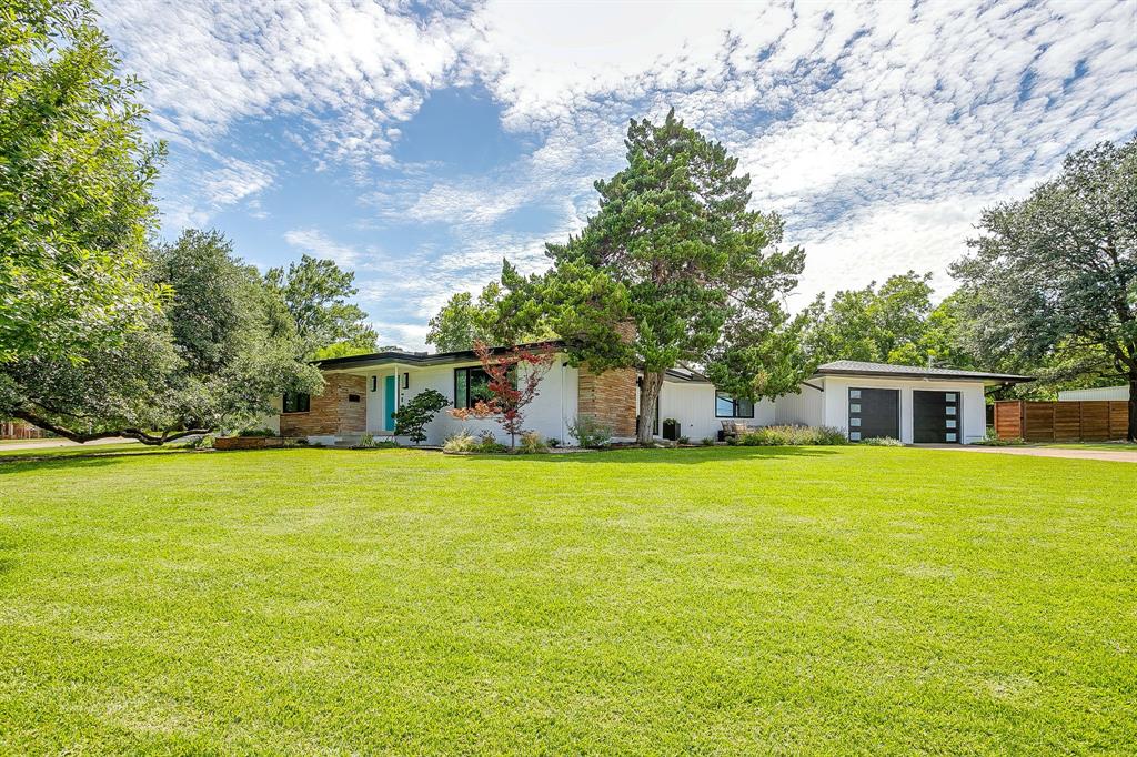 Nestled beneath a magnificent mature oak on an exceptional 0.83-acre corner lot, this extensively renovated Mid-Century Modern blends timeless architecture with today's luxury finishes and modern conveniences in one of Fort Worth's most sought-after neighborhoods.

Offering 3 bedrooms, 2.5 updated baths, a private office, and an attached two-car garage, the home features approximately 2,254 square feet of thoughtfully designed living space ideal for everyday living and entertaining.

Natural light fills the open interior, showcasing refinished white oak hardwood floors, custom millwork, designer lighting, and a beautifully remodeled kitchen with custom cabinetry, premium appliances, and a coffee bar. Designer paint, wallpaper, and custom murals add warmth and character throughout. The remodeled primary suite offers a spa-inspired bath with luxurious finishes and a relaxing retreat.

Beyond its beautiful finishes, this home has been comprehensively updated with a new composition roof (June 2026), new windows and exterior doors, all-new electrical and plumbing, new insulation, encapsulated crawlspace with dehumidification, tankless water heater, high-velocity HVAC, custom closets, CAT6 wiring, whole-home WiFi 7 capability, security cameras, EV charging, new fencing, and gas stub-outs on both patios.

Outside, the park-like backyard is surrounded by mature trees and lush landscaping, offering privacy and endless opportunities for entertaining, gardening, or future outdoor amenities. A detached workshop provides flexible space for hobbies, storage, or a creative studio.

Just minutes from Camp Bowie, the Cultural District, and Downtown Fort Worth, this thoughtfully restored Mid-Century Modern combines exceptional craftsmanship, extensive updates, and one of Ridglea Hills' most impressive homesites.