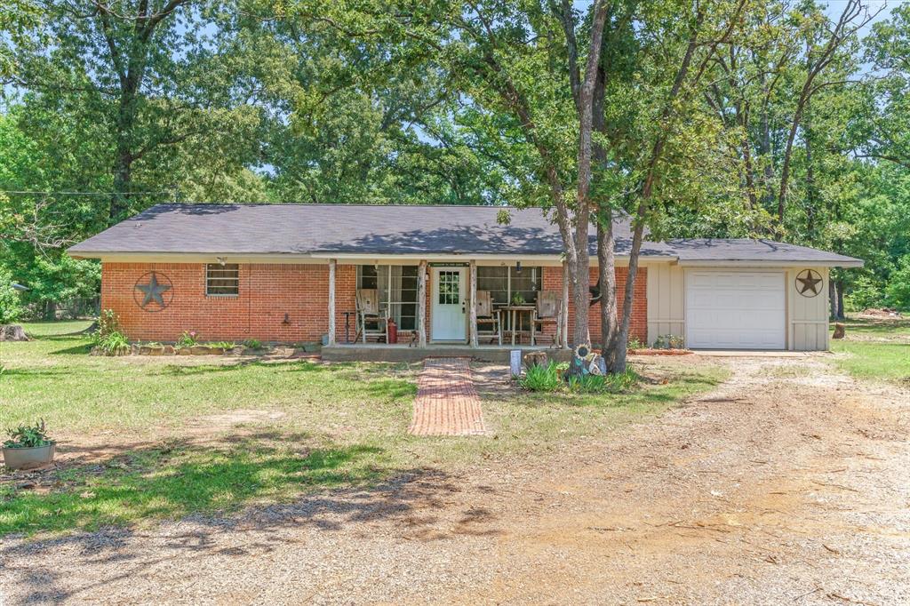 Tucked beneath towering oak trees and surrounded by the peaceful beauty of the East Texas countryside, this charming rustic retreat offers the perfect blend of privacy, functionality, and country living.  Situated on four plus picturesque acres, this 2 bedroom, two-bath home is full of warm rustic character and inviting spaces.  The property features a charming she-shed, tractor shed, open pasture ideal for grazing your cattle or your ponies, and plenty of room to enjoy the outdoors.  Whether you are looking for a quiet homestead, weekend getaway, or a small ranch-style property, this secluded setting delivers the tranquility and freedom of rural living while surrounded by nature.