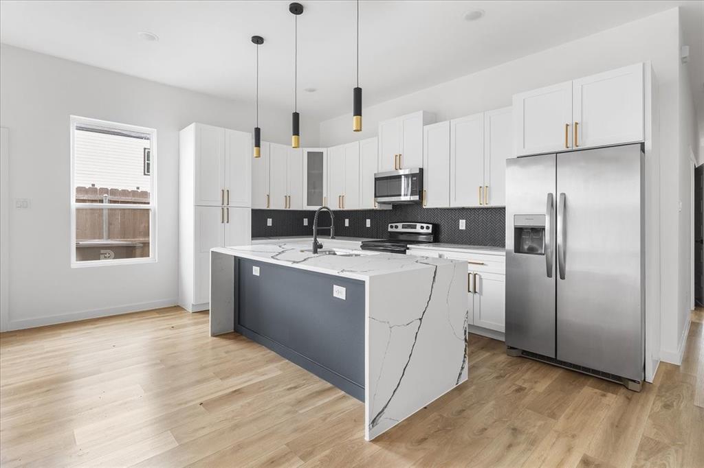 Discover a contemporary new-construction half-duplex in central Dallas - 4 beds, 2 baths. Bright, open floor plan with plenty of natural light. The chef-ready kitchen features quartz counters, gray shaker cabinets, stainless steel appliances, and a large island that flows into the living and dining space. This unit is being sold individually, the other side is already sold. Ideal for rental income or Airbnb, situated in a rapidly developing neighborhood with quick access to highways, shopping, and restaurants. Ready for immediate move-in.