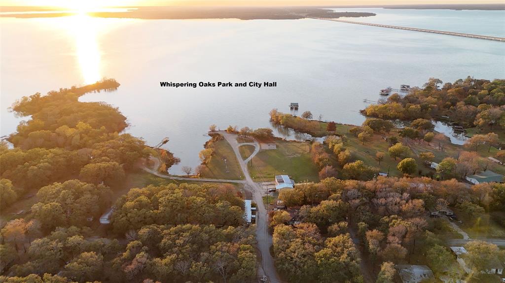 Welcome to Whispering Oaks (Lot #447), a wonderful lake community with NO HOA restrictions. This nice-sized lot (.40 acres) is the perfect opportunity to build your custom home, whether you're looking to build and flip, invest, or create your forever home near the lake. Enjoy the convenience of city water and city sewer, along with co-op electric service through Farmers Electric, making the building process that much easier. The neighborhood offers a peaceful setting while still providing essential utilities already in place. Whispering Oaks also features a community park and even has its own city hall, adding to the charm and sense of community. With close proximity to the lake and a relaxed atmosphere, this property offers a great balance of country living with everyday conveniences. Manufactured homes are prohibited. Survey is the buyer’s responsibility. Boundary lines shown in all photos are approximate. Lot #446 is also available (MLS #21225786) and may be purchased separately or together for additional space and flexibility. All information is deemed reliable but not guaranteed. Buyer and buyer’s agent to verify all information provided.