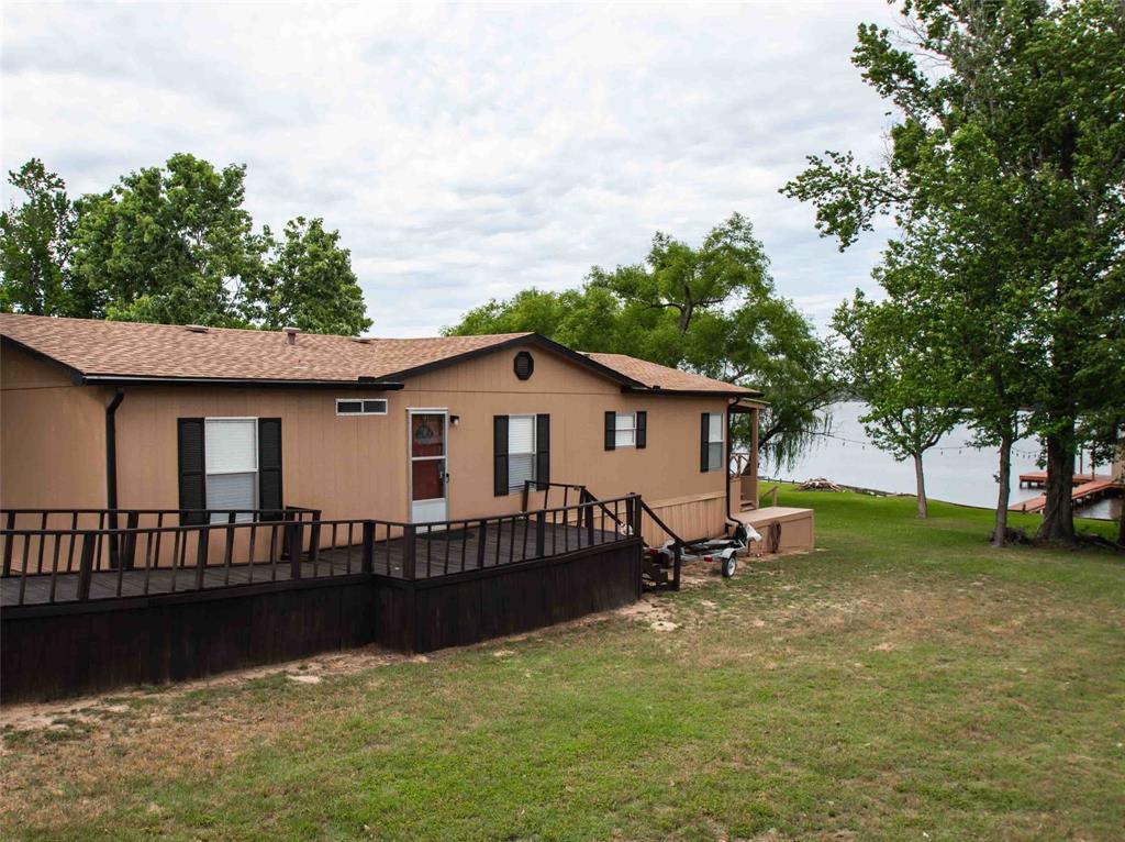 WATERFRONT LIVING:  This 1568 sq. foot 3 bedroom 2 bath waterfront doublewide built in 1998, offers the ultimate lakefront lifestyle.  Situated on a generous 0.21 acre lot in the gated Hickory Hills community on the 365 acre spring fed Callender Lake,  it features 65 feet of private water frontage- perfect for weekend getaway or peaceful full-time living.  Head out from your back deck and walk out to your large boat house and dock that includes a 100 sq. foot storage area for your water toys, a jet ski lift, covered and uncovered deck space and views of the lake.  The home has fresh paint outside and inside and has been updated through out.  Updates to the home include luxury vinyl flooring, natural wood trim, textured walls, updated bathrooms and kitchen. new AC-Heat about 3 years old and so much more for your perfect lake house.  Hickory Hills is a gated community located on the 365 acre spring fed Callender Lake.  It has great fishing, swimming, boating, and other water sports for your enjoyment.  There is also a 15 acre lake called Hickory Hills lake where the ducks and geese reside and only non motorized boats are allowed.   The community also has a community pool, restroom and shower facility, boat ramp, fishing pier, lake swim area, and a children's park.  Make plans today to come see this great property and start living the LAKE LIFE!!.