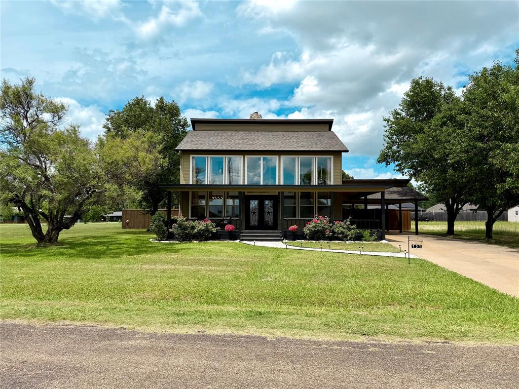 Extensively remodeled home in the gated Spanish Shores community with beautiful water views, quality finishes throughout, and neighborhood boat launch access just a short walk away. Fully furnished is negotiable as well! This 4 bedroom, 2 bathroom, 2-story home offers approximately 1,760 square feet with soaring vaulted ceilings, tall windows, a stone wood-burning fireplace, and a standout spiral staircase that gives the main living space real character. The renovation includes new flooring throughout, new windows, new appliances, granite countertops, updated fixtures, fresh interior and exterior paint, and a recently replaced roof. The primary suite features French doors leading to the paved backyard patio, while the home also offers good-sized walk-in closets and nice storage throughout. Outdoor living is a major part of the appeal, with a covered front deck, upstairs rear deck, landscaped yard, concrete patio space with power in place for a future hot tub setup, attached 2-car carport, and additional boat parking behind the fenced area. City water, city sewer, and electricity are connected. A polished Spanish Shores lake-area home with water-view appeal, community boat launch access, and a move-in-ready feel at Cedar Creek Lake.