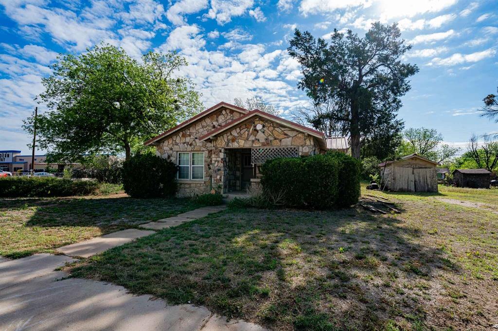 This cozy 1940s rock home is full of character, boasting original hardwood floors, classic craftsmanship, and a charming clawfoot tub. The home includes 2 bedrooms, 1 bath, a handy basement, a covered back porch, and a storage building for all your extra needs. Centrally located in the heart of Haskell, this property offers great small-town living. Sitting on a corner lot with an additional lot, mature pecan trees, and your own water well, this home combines vintage charm with plenty of space to enjoy and make your own.