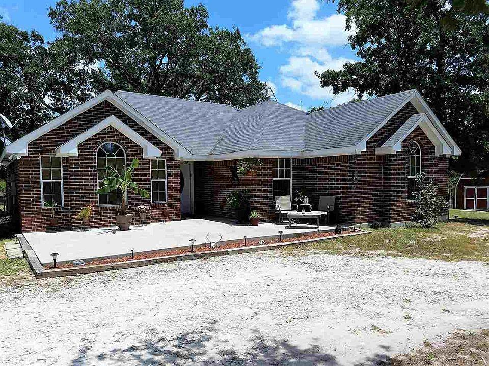 Welcome to your own slice of Texas countryside! This beautiful 4-bedroom, 2-bath brick home sits on 14 fully fenced acres, offering the perfect blend of privacy, comfort, and endless opportunity. Surrounded by mature trees and peaceful scenery, this property is ideal for those seeking a serene rural lifestyle. Enjoy outdoor living with a covered carport, a barn-style shelter perfect for animals, etc, plus a water tank (pond) and a seasonal creek. Whether you’re dreaming of starting a small homestead, raising livestock, or simply enjoying the open space, this property has unlimited potential. Tucked just outside of Groesbeck, you’ll love the quiet country setting with convenient access to town. This is your chance to own acreage, a solid brick home, and the freedom to make it your own.