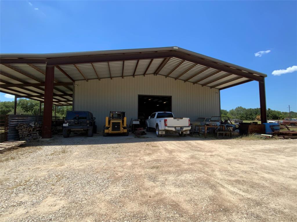 Discover the perfect balance of production, recreation, and premium structural integrity on this exceptional 89-acre ranch. Boasting highly desirable county road frontage on two sides, this versatile property offers effortless access while maintaining a private, expansive feel.

The land features 35 acres of improved coastal Bermuda grass—ideal for hay production or grazing—with the remaining acreage in lush native pasture. Heavy native cover is anchored by massive, mature live oaks and scattered mesquites, creating a thriving habitat for local wildlife, including deer, turkey, wild hogs, and bobcats. Two wet-weather creeks converge on the south end of the property, adding exceptional character, seasonal water flow, and a natural travel corridor for game.

The ranch's crown jewel is a massive, over-engineered 60x100 metal shop (9,600 sq. ft. total under roof). Built to last generations, it is anchored by 18-inch piers buried 10 to 12 feet deep. Supporting infrastructure is fully established, including two reliable water wells, a stock tank, heavy-duty pipe cattle working pens, and a dual 500-gallon septic system already in place.

With its sandy loam soils and ideal topography, this acreage is perfectly suited for horses, a private arena, or a top-tier equestrian estate.
Central Accessibility: Exceptionally located just 1.5 hours from Fort Worth, Austin, Waco, and Abilene.

Equestrian Hub: Within 30 minutes of major local equestrian and barrel racing arenas.

Whether you are looking to build a custom ranch home, establish a premier horse property, run cattle, or enjoy top-tier Texas hunting, this rare combination of improvements and location is ready for its next chapter.