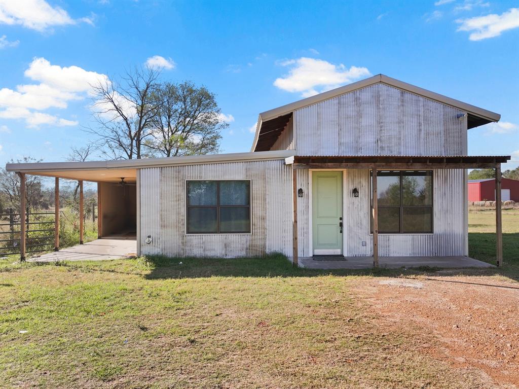 Escape the hustle and bustle with this charming barndominium on approximately 11± acres in Chapel Hill ISD! This adorable 2-bedroom, 2-bath home offers 1,240 square feet of comfortable living space with an open floorplan and durable stained concrete flooring throughout. The kitchen features sprawling granite countertops, built-in cabinetry, a breakfast bar, and a spacious pantry—perfect for everyday living or entertaining. Both bedrooms include large closets, and the primary suite offers an ensuite bath for added privacy. Enjoy peaceful mornings and quiet evenings on the covered patio overlooking gently rolling acreage. This tract is the perfect ranchette, whether you're looking to make it your homestead, or simply want to enjoy the countryside on the weekends. Located just minutes from town, this property offers the perfect blend of rural living and convenience.