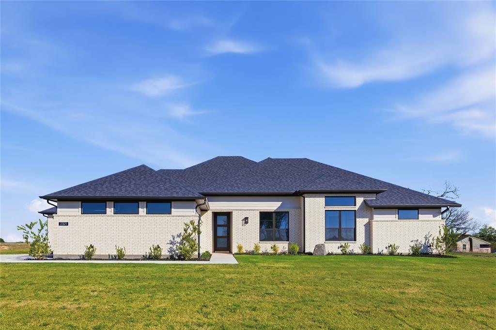 Set on just over an acre in Waterfall Ranch, 2321 Aleman offers the kind of space and privacy that’s becoming harder to find—paired with thoughtful design and everyday functionality. This single-story home features 4 bedrooms, 3.5 baths, a dedicated study, game room, and a spacious three-car garage, all laid out with an easy, open flow. The main living area is anchored by soaring vaulted ceilings and a floor-to-ceiling fireplace, with wide-plank wood floors carrying throughout. Expansive sliding doors frame the backyard and open to a covered patio, creating a seamless connection between indoor living and the acreage beyond.

The kitchen sits at the center of the home, finished with rich cabinetry, quartz countertops, a large island with seating, built-in appliances, and generous prep space—designed for both daily living and hosting. Nearby, the dining area offers a natural gathering space with views of the backyard. A front-facing study with glass doors provides a quiet workspace, while a separate game room adds flexibility for media, play, or fitness. The private owner’s suite is tucked away with a spacious layout and a well-appointed bath featuring dual vanities, a soaking tub, walk-in shower, and ample storage. Three additional bedrooms are well-sized and supported by two full baths, along with a powder bath for guests.

With over an acre to work with, there’s room to expand your lifestyle—whether that’s a future pool, outdoor living space, or simply more distance from everything around you. A rare combination of space, design, and livability—just outside the city, without feeling disconnected.