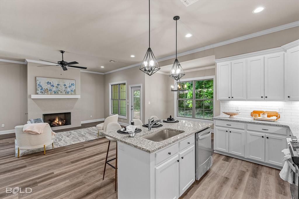 Why settle for old when you can own brand new? Step into luxury, comfort, and peace of mind with a stunning new construction home, built for the way you live today! This stunning new construction offers modern living with style and comfort. Featuring 3 spacious bedrooms and 2 full bathrooms, this home showcases beautiful vinyl plank flooring, granite countertops, stylish light fixtures, and fresh paint throughout.  The inviting living area includes a cozy fireplace, perfect for relaxing evenings. The primary suite is a true retreat with dual sinks, two walk-in closets, and a private bathroom designed for comfort.  Enjoy peace of mind with a 1-year home warranty on appliances, and take advantage of one of the largest lots in the neighborhood!  Ideal for entertaining, gardening, or future expansion. Don't miss this opportunity to own a brand-new home with thoughtful finishes and plenty of space!  Land Rush Properties LLC Builders don’t just build homes, they craft the foundation for lasting memories and family dreams. Come see the quality and care for yourself.