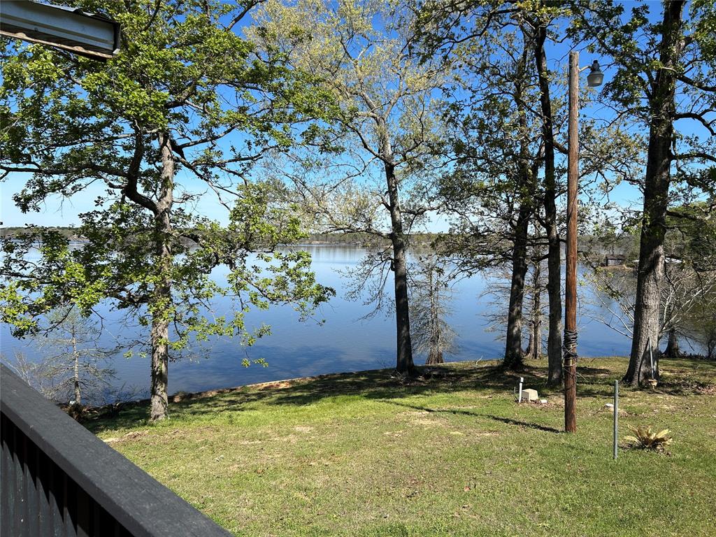 Looking for your place on the lake! This home features a large pie shaped lot with great water views and a fishing pier.  The Kitchen and Living area just receive a facelift with bright white bead board and trimmed with dark stained trim.  Bathroom has a fresh coat of paint and new flooring. Ready to fine your spot on the lake? This little gem has a large pie shaped lot with plenty of water access. It will make a great home or weekend getaway. The porch has a great view of the lake where you can sit and sip your coffee in the morning. This small home has huge windows that make it feel larger and bring you closer to the lake. New metal roof.

All measurements should be verified by buyer.