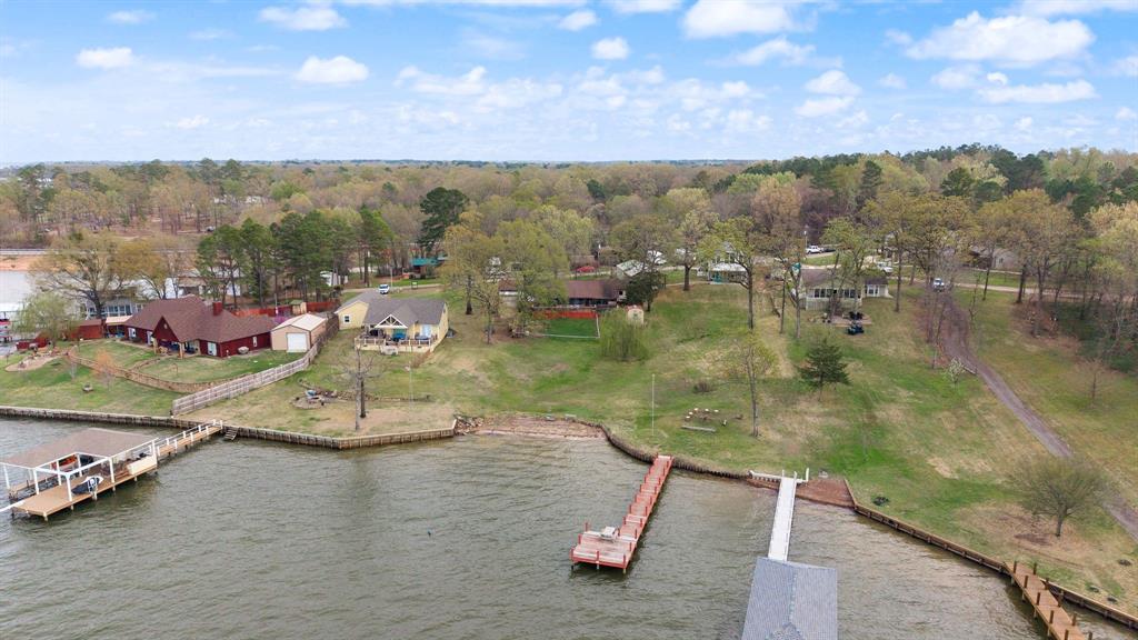 The lakefront property you’ve been waiting for! Sitting on over a half-acre lot on Lake Bob Sandlin, this charming 3-bedroom, 2.5-bath home offers amazing water views, a walk-out to the lake, and beautiful sunsets, and presents an excellent opportunity for a short-term rental, Airbnb, or income-producing vacation property. Relax or entertain on the large deck overlooking the water or unwind in the screened-in back porch with peaceful lake views. Inside, you’ll find a wonderful flowing floor plan with a bright and spacious living area featuring a cozy wood-burning stove and built-ins, all open to the dining area and kitchen. The kitchen offers a breakfast bar along with plenty of cabinet and counter space.
The spacious primary suite includes an ensuite bath with dual sinks, a large soaking tub, and a separate walk-in shower. The two additional bedrooms are located on the opposite side of the home and share a convenient Jack-and-Jill bathroom. Wonderful neighbors and a tranquil lakeside setting make this home a true retreat. Whether you're enjoying morning coffee by the water or watching the sunset from your deck, this home offers the perfect blend of comfort, nature, and lakefront living.