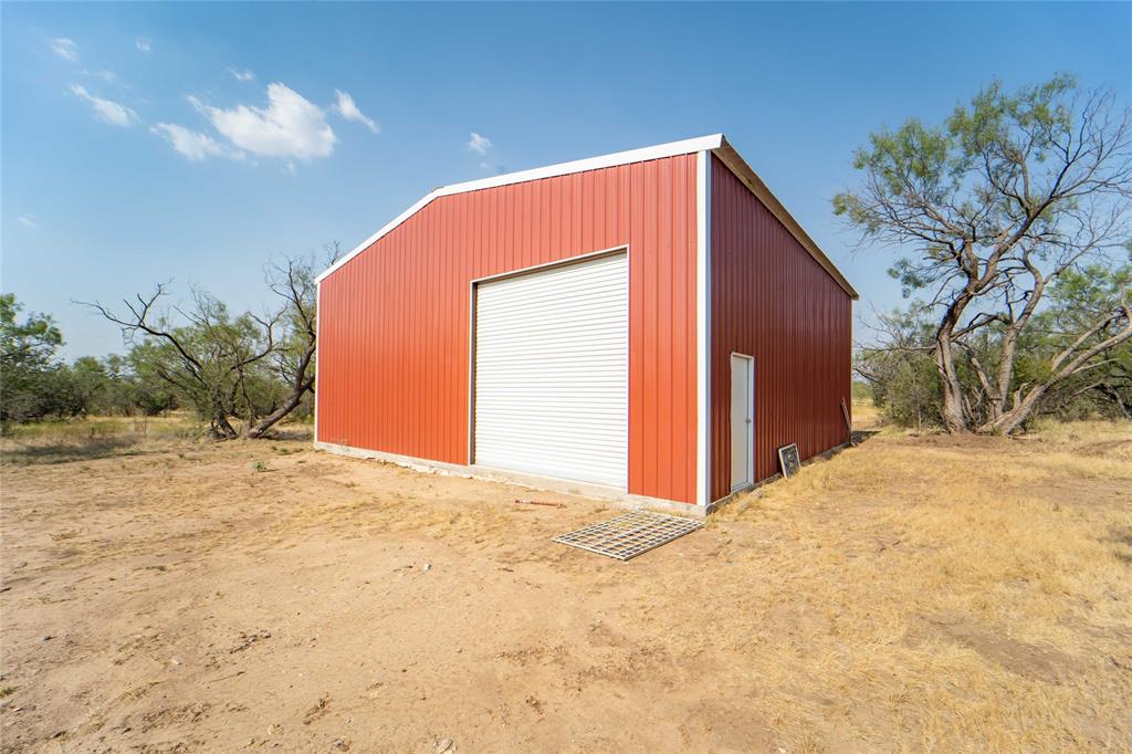 Don't miss out on an awesome opportunity to own acreage in Shackelford County. An area known for great hunting and fishing, this wooded 21-plus acres, with current survey available, lends itself to multiple uses! Residential, recreational or agricultural , the choice is yours! Nice, black pipe entry, completely fenced, set up with a 2023 40x40 insulated metal build with a 12.5x14 roll up door, plumbed for a septic and  just waiting for you to take it to the next level! There is a  beautiful elevated spot absolutely perfect  for a homesite or just set up your hunting camp and watch the sun set!  Fort Griffin Special Utility District water meter already in place and there is a nice tank on the property as well!  Comanche County electric Co-op service has been brought onto the property. Call today and set up an appointment and let's get your plans started for living THE country life! (Located approximately 8 miles east of Albany townsite.)