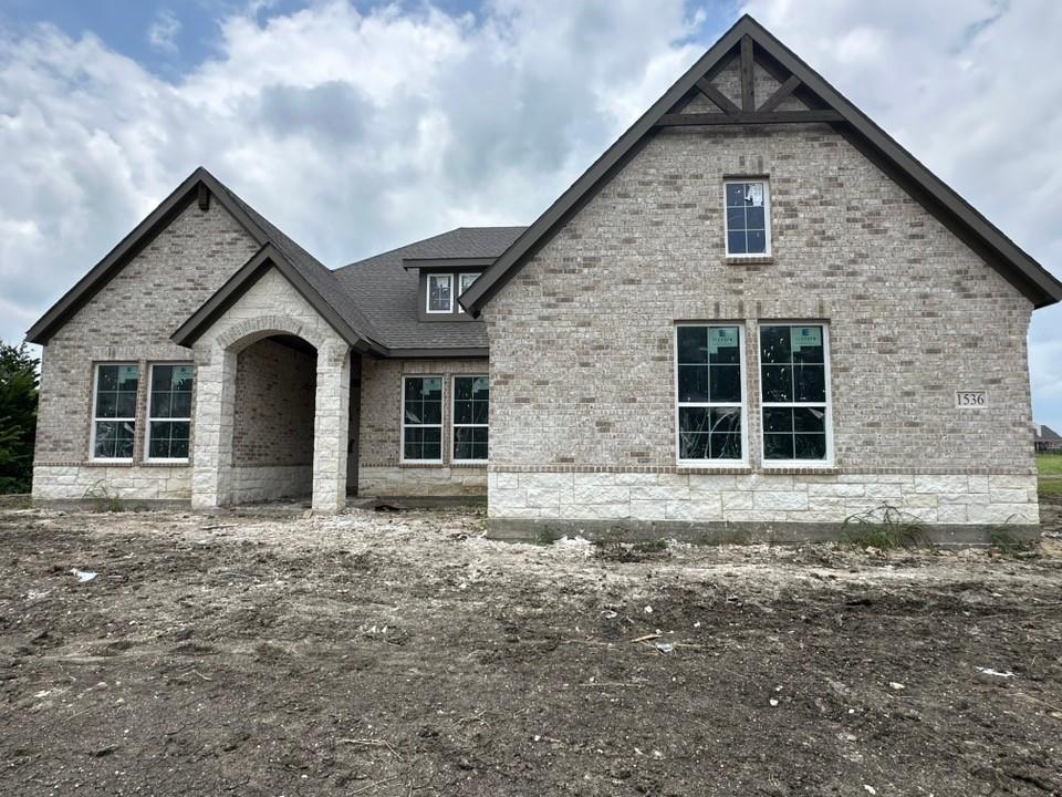 Estimated September 2026 completion! Ask us about our Trade In Trade Up program, we can buy your home! The Verbena floor plan features a modern, open-concept layout and the sought-after features today’s homeowners are searching for. With four bedrooms, three bathrooms, and a flex room, this plan boasts just over 2,400 square feet of functional living space. Upon entering the home off the front porch, you’re welcomed by an inviting foyer. Immediately to the left is a hallway with a bedroom, walk-in closet and full bathroom, as well as a linen closet. Across the foyer is a flex room, perfect for a home office, formal dining room or whatever need your family has for the space. Past the foyer is the family entry, with storage space and mud bench, which leads to the laundry room and two or three car attached garage. Through the entrance, the home opens up to a large family room with a stately fireplace. Adjacent to the family room is a gourmet kitchen, equipped with a walk-in pantry, ample counter space and an oversized island. Finishing off this open-concept living area is a dining space which overlooks the covered back patio. The remainder of this one-story floor plan is just off the living space. A hall leads to two bedrooms with walk-in closets, another linen closet and a shared full bathroom. The back corner of the home offers privacy for the owner’s suite, featuring a massive walk-in closet and bathroom with a dual-sink vanity, standalone 
soaking tub and glass-enclosed shower.
