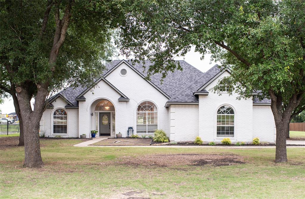 Welcome to your own slice of country serenity in sought after Forney! Nestled inside a gated community on a spacious one acre lot, this beautifully maintained 4-bedroom, 2-bath home offers the perfect blend of comfort, style, and privacy. Surrounded by mature trees and wide-open space, with a solid iron gate built to keep those you love secure, the curb appeal alone makes a lasting first impression.

Inside, you’ll find an open-concept layout with soaring ceilings, abundant natural light, and warm, inviting finishes throughout. The expansive living area centers around a charming brick fireplace and flows seamlessly into the dining and kitchen spaces perfect for entertaining or everyday living.

The home features updated flooring installed within the past four years, giving the entire space a fresh, modern feel while maintaining its cozy character. Spacious secondary bedrooms provide flexibility for family, guests, or a home office, while the oversized primary suite offers a relaxing retreat at the end of the day.

Large windows throughout the home showcase peaceful outdoor views and fill the interior with natural light. The generously sized backyard offers endless possibilities room for a pool, workshop, garden, or simply enjoying the quiet Texas evenings under the trees.

If you’ve been searching for space, privacy, and modern comfort all within a secure gated community, this Forney gem checks every box.