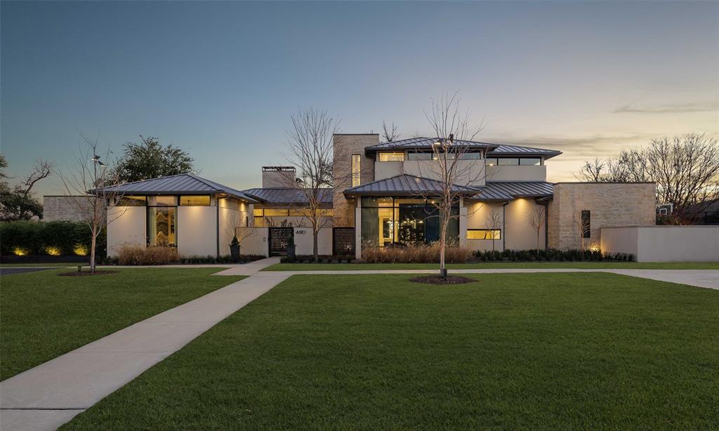 Completed in 2017 and recently remodeled, this Preston Hollow home has 5 bedrooms, 6 full baths, spans 8,966 sqft, and sits on a .79-acre lot. Large windows, hardwood floors, and a neutral palette in the foyer create a stunning entrance. The open and airy great room looks to the kitchen, which is complete with a wet bar, a prep kitchen, and a walk-in pantry. The first level also includes a dining room with a temp-controlled wine room, an office, a media room, a golf simulator, and a guest suite. The first-floor primary boasts a fireplace, new hardwoods, built-ins, and a seating area. A gorgeous bathroom, a sauna, a gym, a safe room, and dual walk-in closets complete the wing. Upstairs, find 3 bedrooms with en suite baths, a bunk room, and a game room with a wet bar and full bath. The backyard offers a covered patio, kitchen, bar, built-in grill, a salt water pool and spa, a fireplace, a firepit, and a turfed backyard and putting green. This stunner checks all of the boxes.