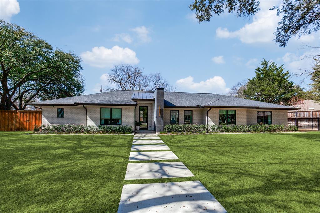 Welcome to 10539 Les Jardins in Dallas, a completely renovated modern ranch that blends timeless architecture with elevated, contemporary finishes. Offering 4 bedrooms plus a dedicated office and 3 beautifully updated full bathrooms and 1 half bath, this home features a spacious and thoughtfully designed layout. Two dining areas provide flexibility for both formal gatherings and casual everyday meals. The expansive living room serves as the heart of the home, highlighted by a striking floor-to-ceiling fireplace flanked by dramatic double iron doors. Oversized windows throughout flood the interiors with natural light, creating bright, airy spaces that feel both inviting and refined. The living room flows seamlessly into the sleek, modern kitchen, anchored by a stunning quartzite island and complemented by stainless steel appliances, clean-lined cabinetry, and generous prep space. Wood floors run throughout the home, adding warmth and continuity to the contemporary design. The oversized primary suite offers a private retreat, complete with a spa-inspired bath featuring a stand-alone soaking tub, separate walk-in shower, and double vanity. Additional bedrooms are generously sized, providing comfort and versatility for family, guests, or creative space. Outside, enjoy a 3-car garage and an expansive, landscaped backyard that is fully fence, perfect for entertaining, play, or relaxing evenings. Move-in ready and thoughtfully reimagined, this modern ranch delivers light-filled interiors, functional flow, and elevated finishes in a prime Dallas location, ideally positioned within Preston Hollow’s coveted private school corridor.