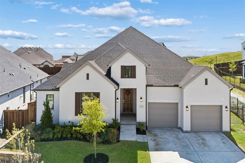 Less than a year old and still under the builder warranty, this Toll Brothers Cisco floor plan offers a rare opportunity to enjoy one of the largest and most private lots in Walsh. Situated on a massive premium homesite adjacent to greenspace with no immediate neighbor to the right, this home provides room to spread out, play, entertain, and enjoy the outdoors while remaining just steps from Overlook Park and the community's extensive trail system. Inside, elegant white oak engineered hardwood floors lead through a thoughtfully designed layout featuring four spacious bedrooms, three full bathrooms, a private home office, and a dedicated media room. Every bedroom includes a walk-in closet. Soaring cathedral ceilings in both the primary suite and office create a sense of openness, while large windows fill the home with natural light. The kitchen features premium quartz countertops, a gas range, large walk-in pantry, additional custom cabinetry, and upgraded hardware. This tech-forward home is fully prepared for modern living with surround sound wiring, custom light fixtures, dedicated cable and internet ports in every room, and an EV charging outlet in the 2.5-car garage. Outside, the expansive backyard offers space rarely found in Walsh, complete with a brand-new playset and improved drainage. For added peace of mind, the sellers have recently completed a third-party home inspection while the home remains under the builder warranty, allowing any identified warrantable items to be addressed before closing. Located in Walsh and zoned to highly acclaimed Aledo ISD, residents enjoy access to resort-style pools, miles of hike and bike trails, parks, playgrounds, pickleball and tennis courts, dog parks, a fitness center with weekly classes and drop-in childcare, year-round community events, and an on-site elementary school. Whether you enjoy gathering with neighbors or simply appreciate having space and privacy at home, this property offers the best of both worlds.
