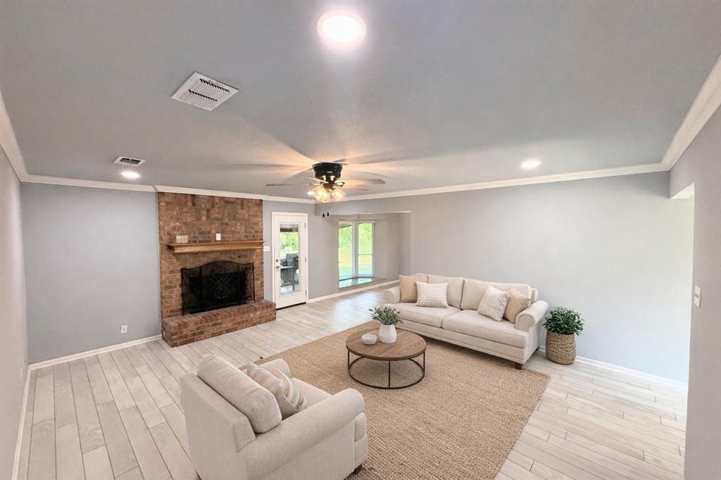 Fantastic 3 bed 2 bath brick ranch-style home in the soughtafter McLelland addition.  The home was completely renovated when the owner purchased- AC, HVAC, windows, kitchen, bathrooms, doors, insulation, ducting, appliances, flooring, ceiling fans and more.  A large living area with wood burning fireplace opens up to a cute dining space with large bay window and views of the backyard.  The kitchen is complete with custom-made, soft close cabinets and drawers, brushed nickel finishes and stainless steel dishwasher and electric range. There is a separate laundry room just off of the kitchen that contains a pantry and washer and dryer hookups.  Luxury vinyl throughout in the lightest shade of gray with black grout for a standout design.  The master has a large closet and en suite bathroom enclosed behind a sliding barn door.  The bathrooms have granite countertops, custom cabinetry and marbled showers.  There are two linen closets for extra storage as well as recessed lighting and crown molding throughout! The 2-car garage is spacious and has an office with built-in desk and large storage room as well. The expansive and open .38 acre property backs to a large, open and well-manicured field which is perfect for watching those beautiful morning sunrises.  Cute gray shed has been recently installed and is on a slab foundation as well.  This home has been meticulously cared for and is move-in ready! Would love to show you this fabulous home today.  *Some photos have been virtually staged for enhancement purposes.