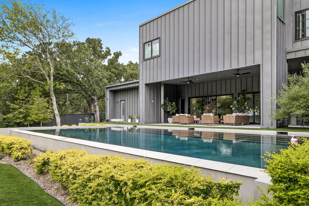 Curated by DMOD Design+ Build, this exceptional Southlake residence features five bedrooms with four and a half baths and encompasses 5,100 square feet with a three car garage. Designed for convenience and luxury, the home features two laundry rooms, a spa-inspired primary suite with sliding doors to the outdoors, a full media room with wine fridge, Wi-Fi and smart home integration, and whole-home audio. The chef’s kitchen comes with a full Viking appliance package, four ovens, eight gas burners, two dishwashers, Mont Blanc Quartzite countertops and backsplash, and European white oak cabinetry. Outdoors, the tranquil and private grounds is flanked by a 50’ x 25’ pool and also features a pool bath, outdoor shower, covered outdoor patio, and turf. Energy efficient and meticulously maintained, this home seamlessly blends modern elegance with resort-style amenities—perfect for both entertaining and everyday living.