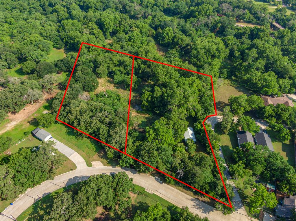 Imagine building your dream home on an Old Former Peanut Mill site with some discernible evidence of its existence still on the property. This stunning acre-plus property, surrounded by huge mature native pecan trees and some oak trees with open skies. Enjoy peace of mind knowing your backyard view is protected, with no future development allowed behind you without FEMA approval. There is ample room for your horses to roam, There are Cattle pens on the property, and you can stroll to downtown Mansfield while still savoring the tranquility of country living. City has already approved a plan to build a 2,500 square foot home on this property. With easy access to major freeways, convenience meets serenity. The neighboring lot (MLS 21288950) is also available, offering the perfect opportunity for a multigenerational homestead. Choose one lot or both to suit your vision.