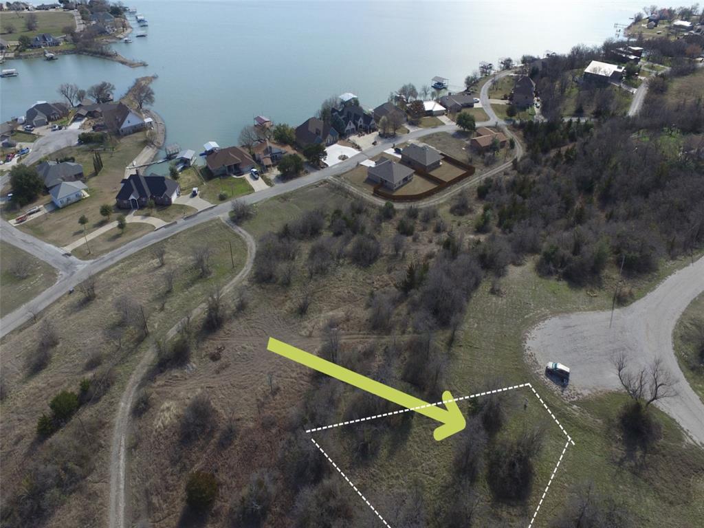 This exquisite lot is ideally situated at the corner of a cul-de- sac, offering both convenience and privacy. Lined with trees, the entire rear of the property enjoys a secluded atmosphere. The rocky soil ensures a solid foundation for building atop the elevated hill. The lot's strategic positioning eliminates any concern of flooding from the lake or heavy rains. Additionally, a well-designed home on this lot provides a direct, picturesque view of Runaway Bay Lake. Nestled in the serene small town of Runaway Bay, this area embodies the charm of country living while remaining in close proximity to essential stores and gas stations. Notably, the lake boasts inviting beach-like entrances and sandy shores. Nearby boat docks facilitate convenient storage, and the city treats residents to yearly firework displays that can be savored right from the comfort of your own front yard!